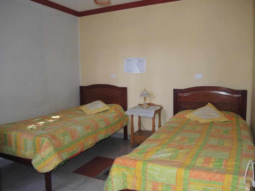 En eller flere senge i et værelse på Hostal Valle Hermoso
