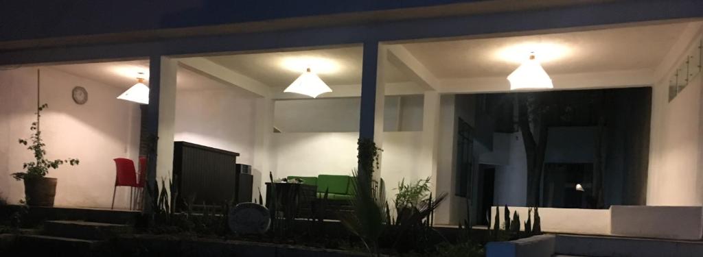 a house with two lights on the windows at night at El Arrayan in Valle de Bravo