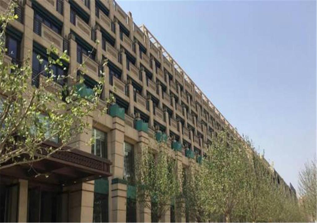 a large building with ivy on the side of it at Ascott Riverside Garden Beijing in Beijing