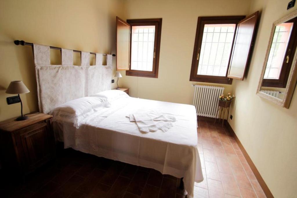 Postel nebo postele na pokoji v ubytování Corte Stellata Holiday Apartments