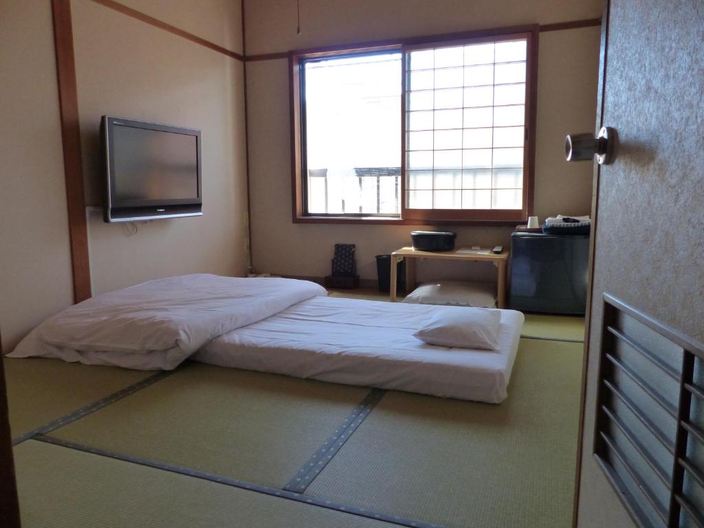 Krevet ili kreveti u jedinici u objektu Minshuku Kuwataniya