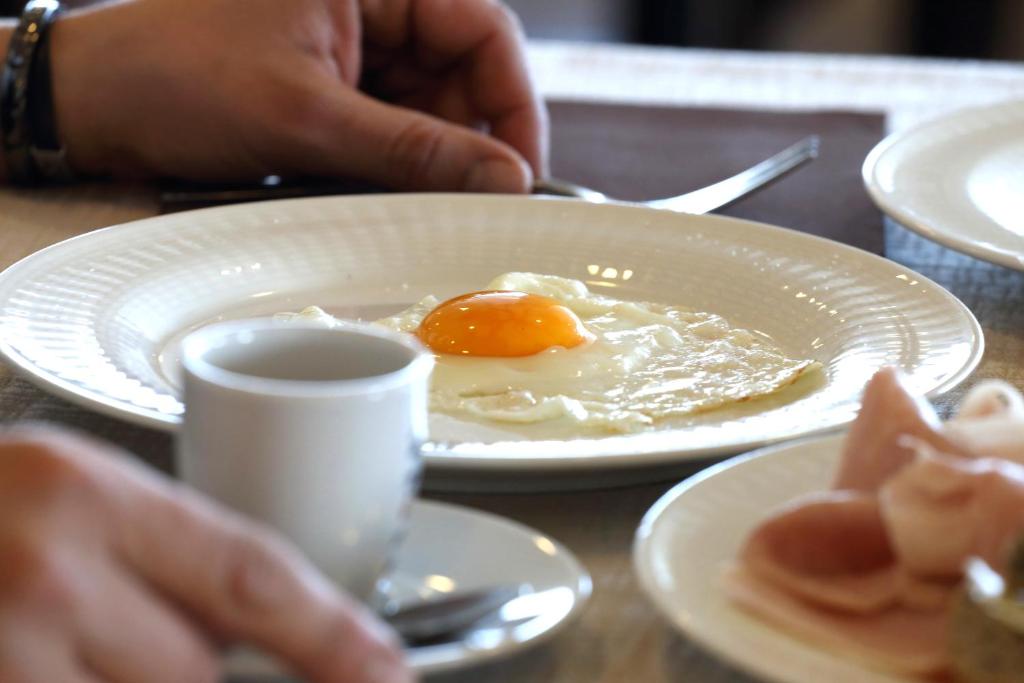a plate with an egg on top of a table at Hotel Du Soleil in Rimini