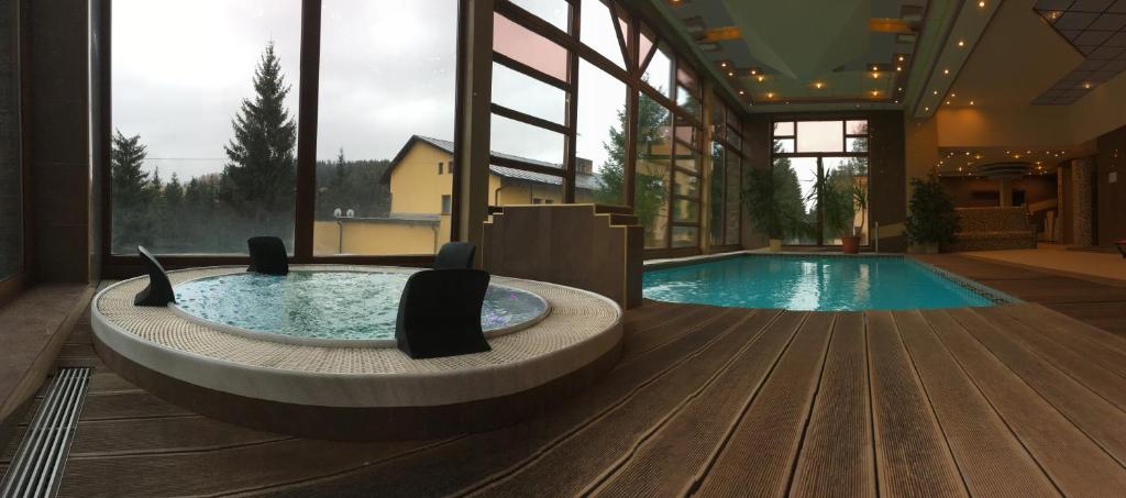 a large pool with a hot tub in a building at Holiday Park Orava - Hotel Orava in Dolný Kubín