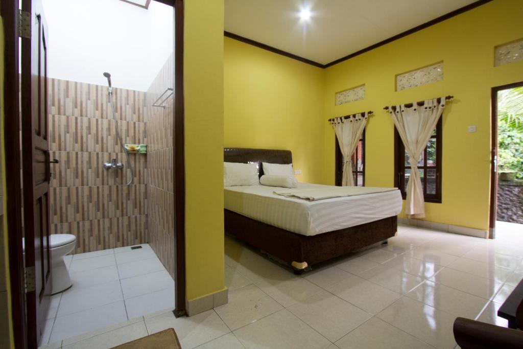 Postel nebo postele na pokoji v ubytování Nova Homestay Ubud