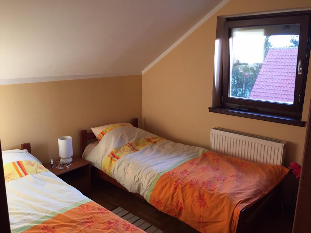 a bedroom with two beds and a window at Apartment Linda in Zlatibor