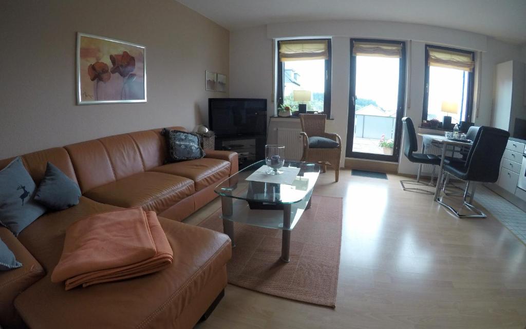 a living room with a couch and a table at Ferienwohnungen Albers in Winterberg