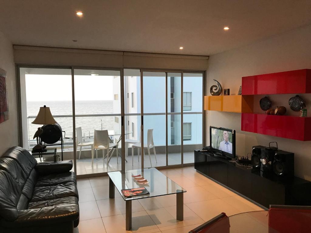 a living room with a couch and a table at Paracas Beach Vacation Rentals in Paracas