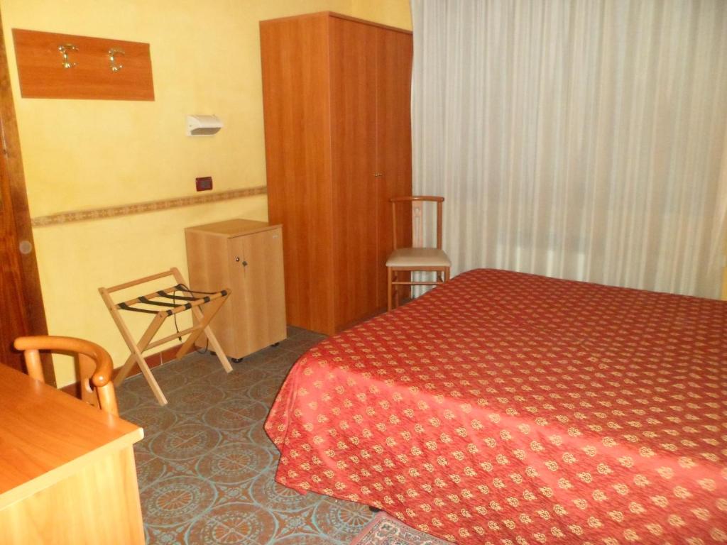 A bed or beds in a room at Motel Tempio