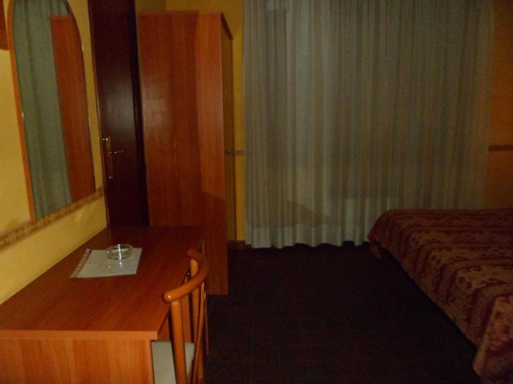 A bed or beds in a room at Motel Tempio