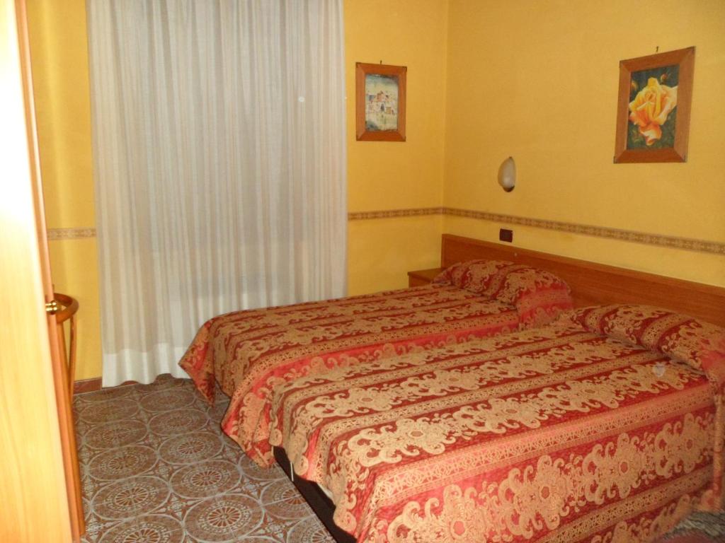 A bed or beds in a room at Motel Tempio