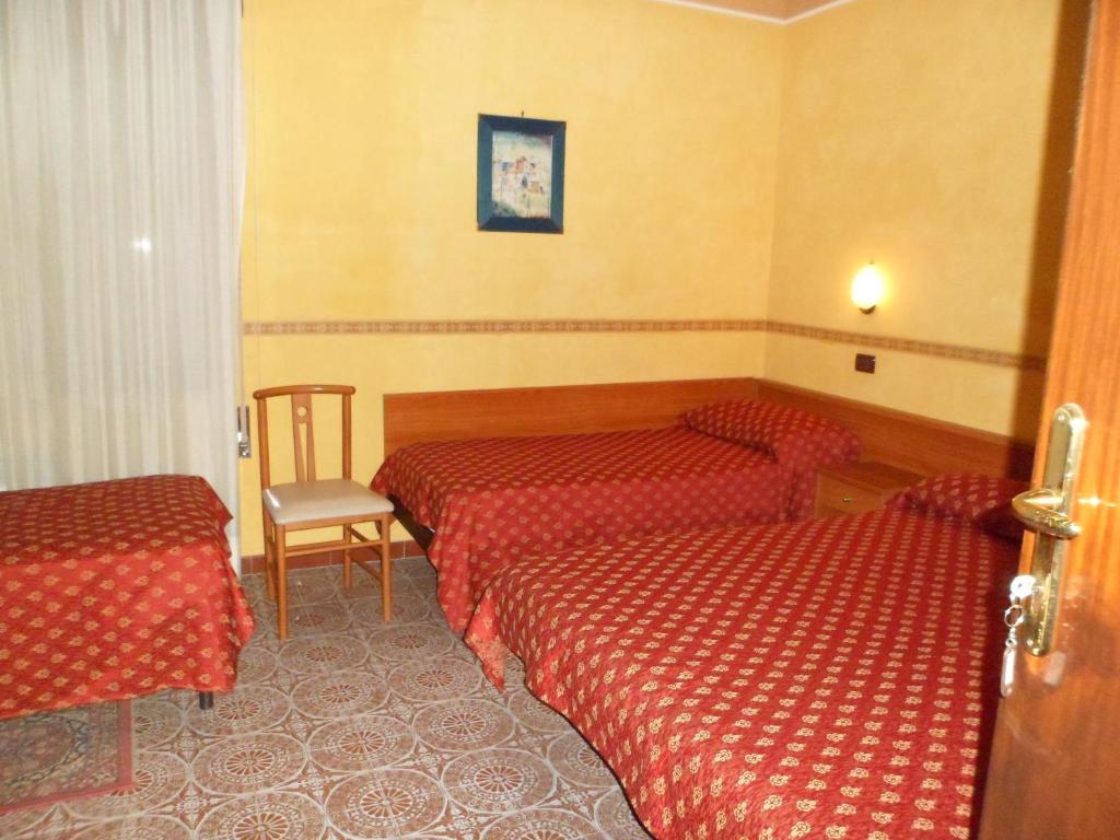 A bed or beds in a room at Motel Tempio