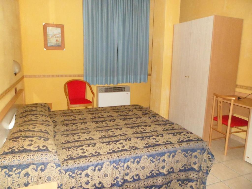 A bed or beds in a room at Motel Tempio