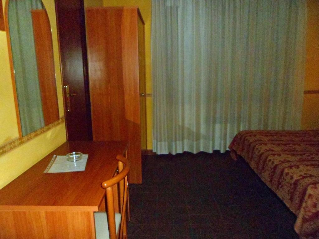 A bed or beds in a room at Motel Tempio