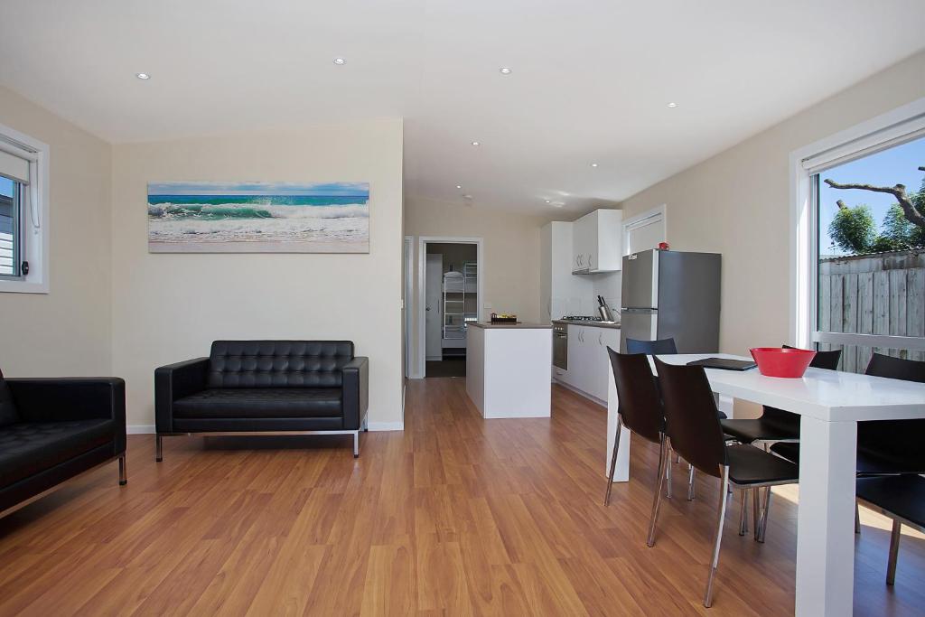 a living room with a table and chairs and a kitchen at Portland Holiday Village in Portland