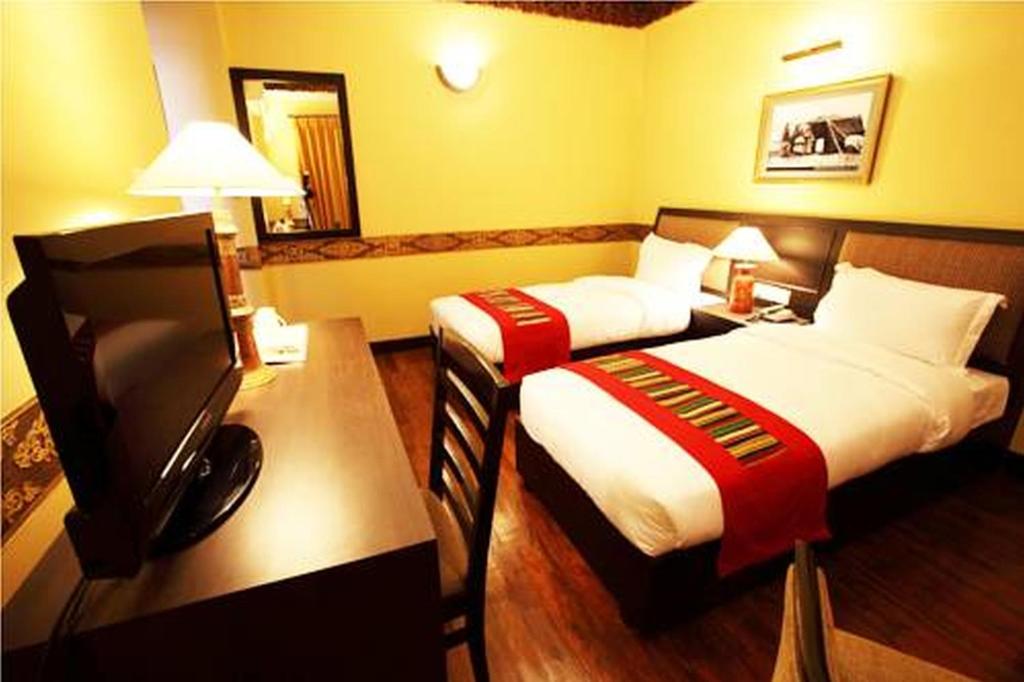 Letto o letti in una camera di Hotel Tibet International