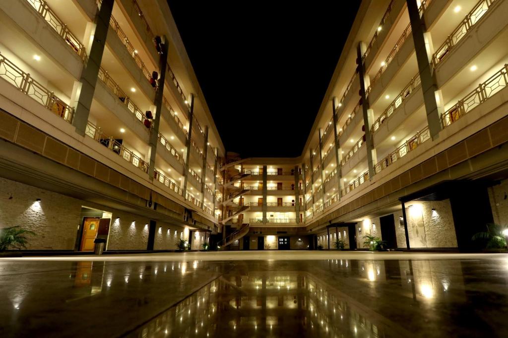 a large building with a courtyard at night at Hotel AGC in Aurangabad