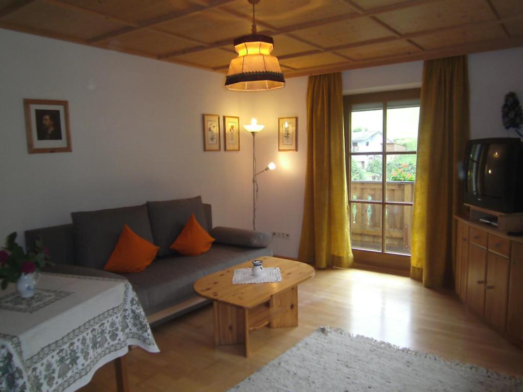 a living room with a couch and a coffee table at Lexhof in Sellrain