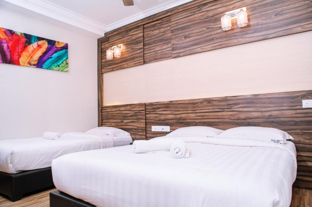 Postel nebo postele na pokoji v ubytování Wan Alyasa Hotel