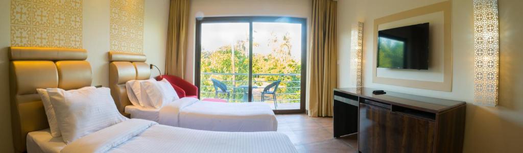 Кровать или кровати в номере The Ivy Anjuna