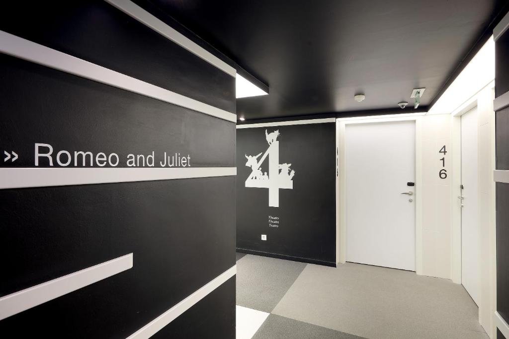 a hallway with a door and a sign on a wall at Eurostars Book Hotel in Munich