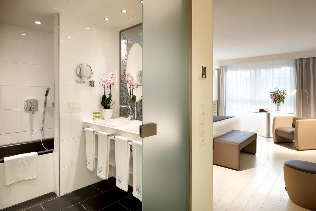 a bathroom with a sink and a mirror at Eurostars Book Hotel in Munich