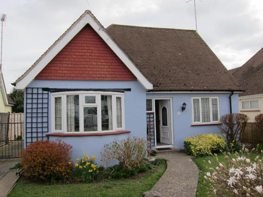 a blue house with a red roof at No 9 in Bognor Regis