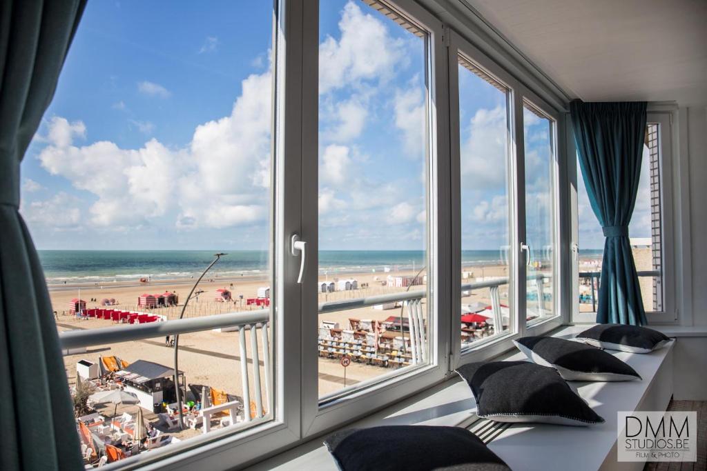 a hotel room with a view of the beach at Novo panoramic sea view in De Panne