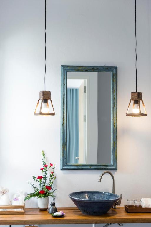 a bathroom with a sink and a mirror on the wall at Krabi Home Resort in Tab Kaek Beach