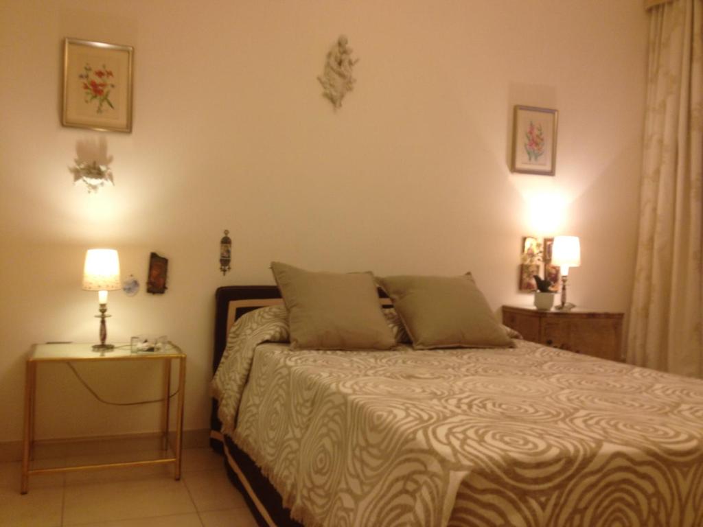 a bedroom with a bed and a table with two lamps at Domus Felix in Sorrento