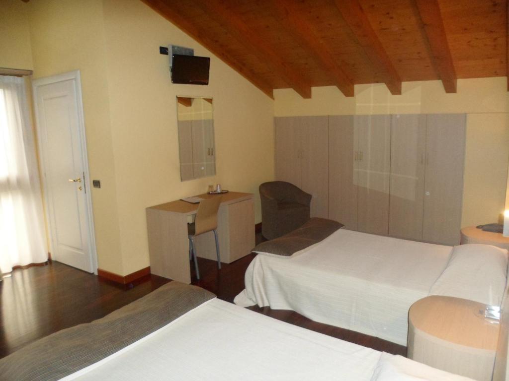 Postel nebo postele na pokoji v ubytování Hotel Fontana Santa