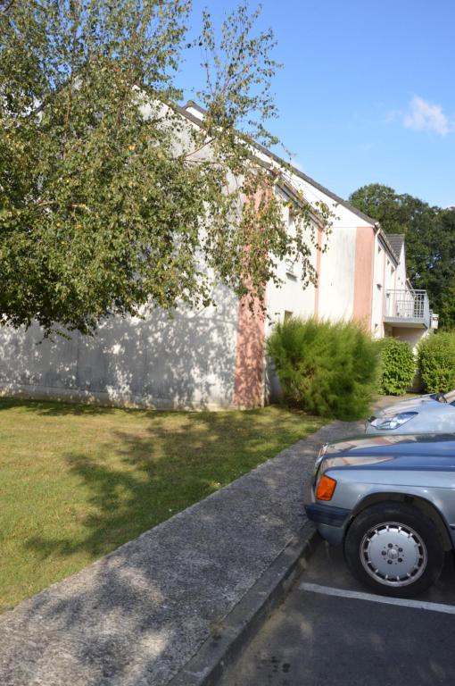 a car parked in a parking lot in front of a house at Le Faidherbe in Albert