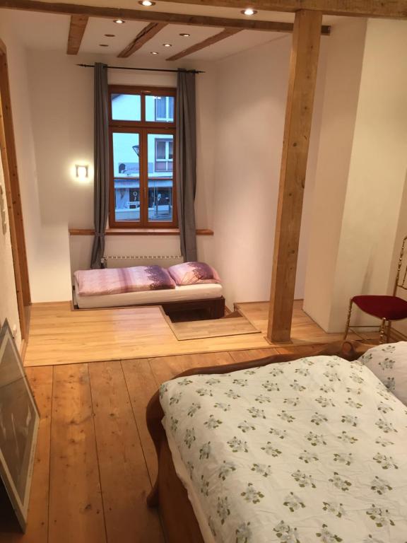 a bedroom with two beds and a window at Boardinghouse Schnaitheim in Heidenheim an der Brenz