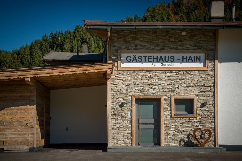 a brick building with a sign on top of it at Gästehaus Hain in Hochfilzen