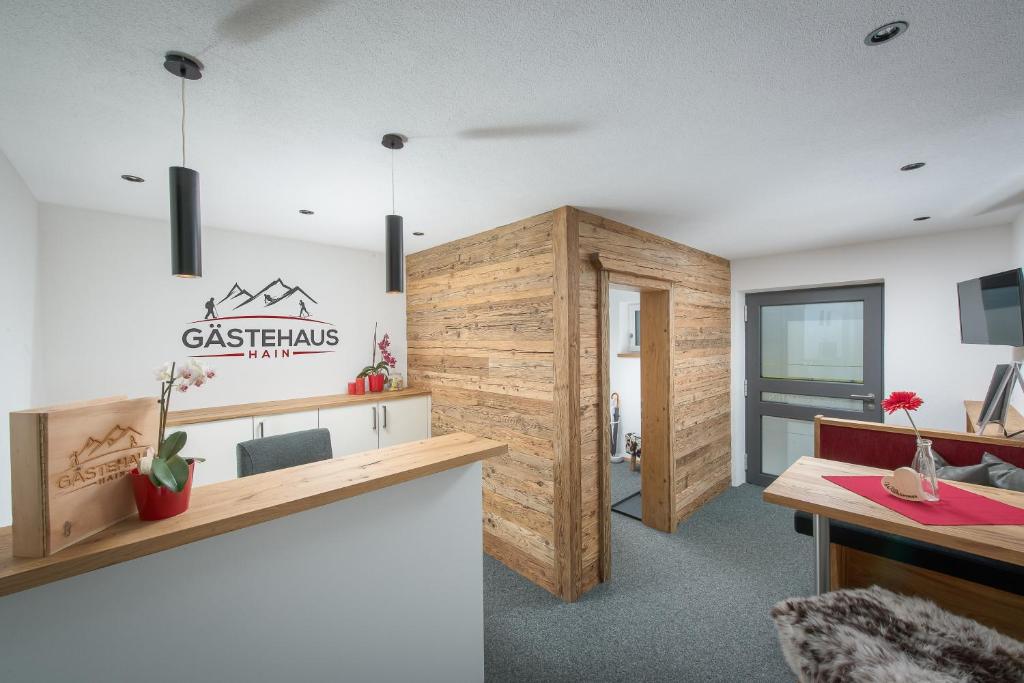 an office with a wooden wall and a desk and a room at Gästehaus Hain in Hochfilzen