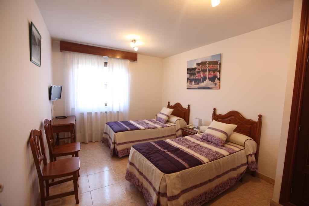 Postel nebo postele na pokoji v ubytování Hostal San Blas