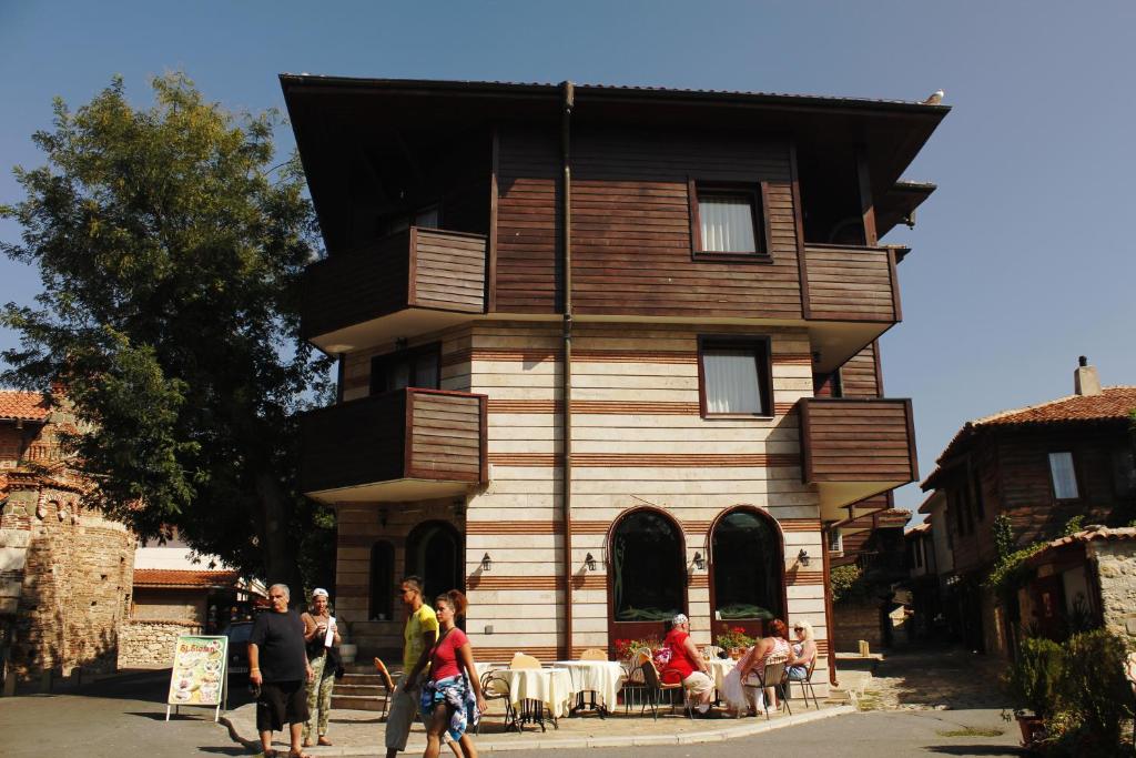 a group of people standing in front of a house at Boutique Hotel St. Stefan in Nesebar