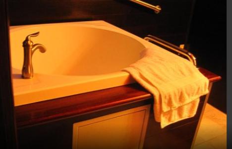 a bathroom with a bath tub with a towel at Apocalypto Motel in Neah Bay