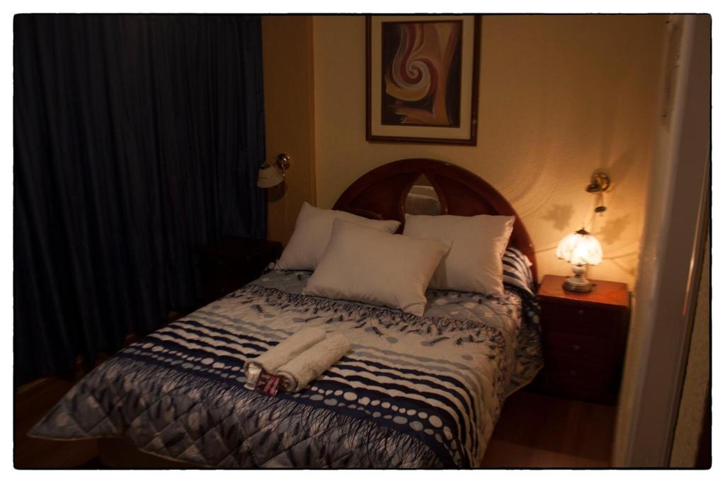 a bedroom with a bed with a towel on it at Sueños del Valle in Sangolquí