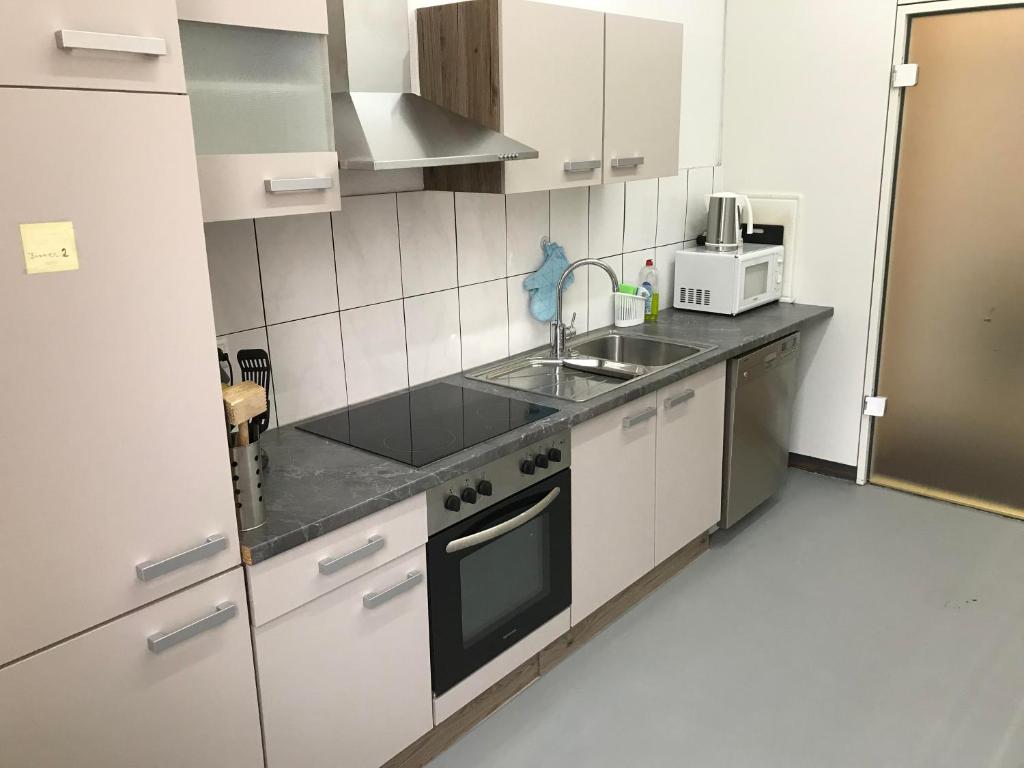 a small kitchen with a sink and a stove at Unterkunft Göppingen in Göppingen