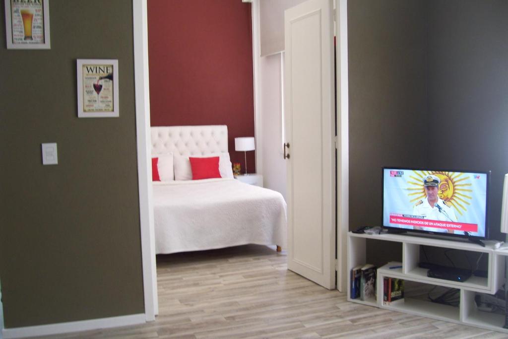 a bedroom with a bed and a tv in a room at Marcelo T de Alvear 800 in Buenos Aires