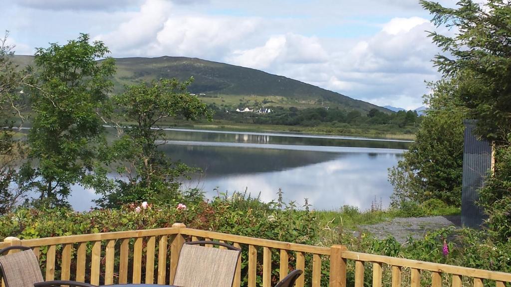 a view of a lake from a wooden bench at Lakeside house in Oughterard