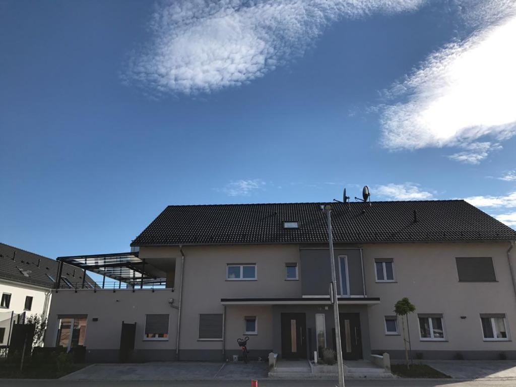 a large white building with a sky in the background at Casa Friedolin in Friedrichshafen