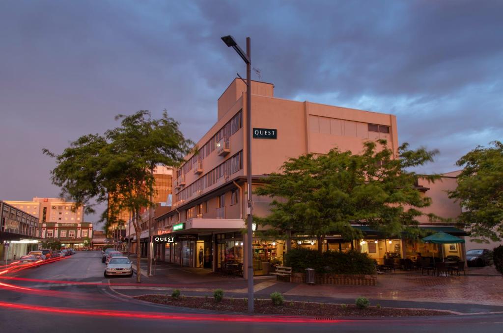 a building on a street with a car on the road at Quest On Ward Serviced Apartments in Hamilton