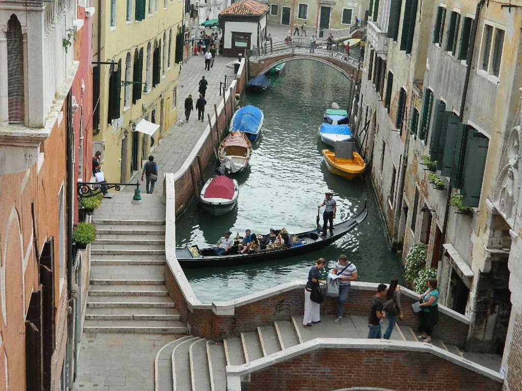 a group of people riding in a gondola down a canal at Venice Dose Guesthouse in Venice