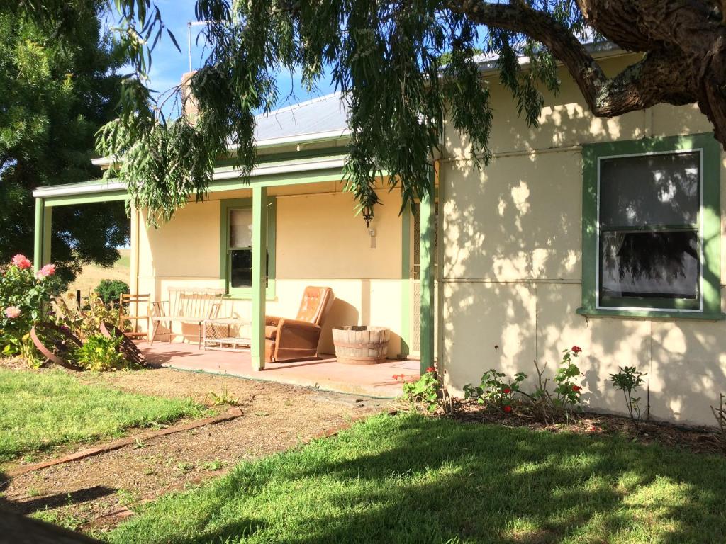 a house with a porch and a couch on a patio at Tarndwarncoort Homestead in Warncoort