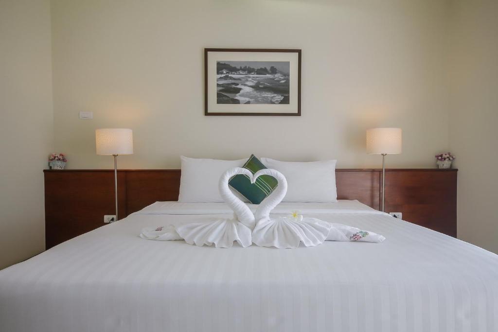 Postel nebo postele na pokoji v ubytování Baan Nilrath Hotel - SHA Extra Plus