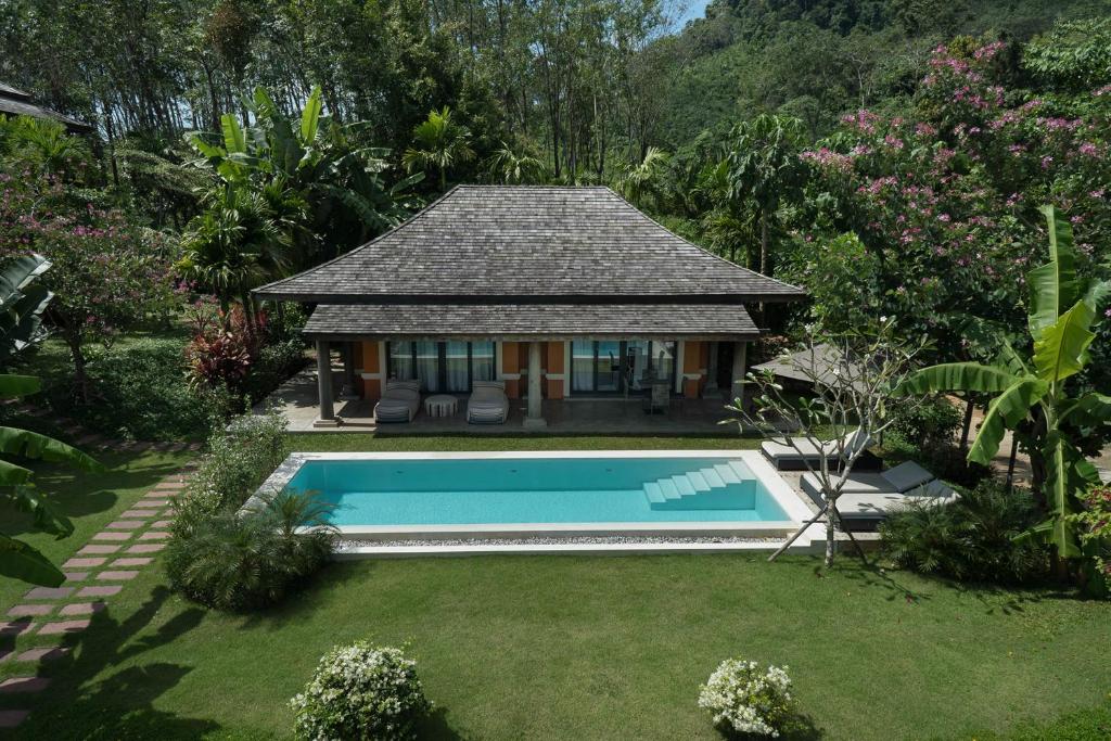 a house with a swimming pool in a yard at Bungalow VILLA Cha Cha in Ko Yao Noi