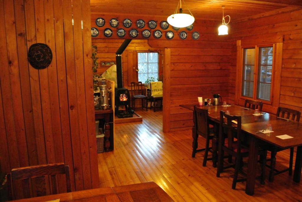 a dining room with a table and chairs in a cabin at Polan no Fue in Minamioguni