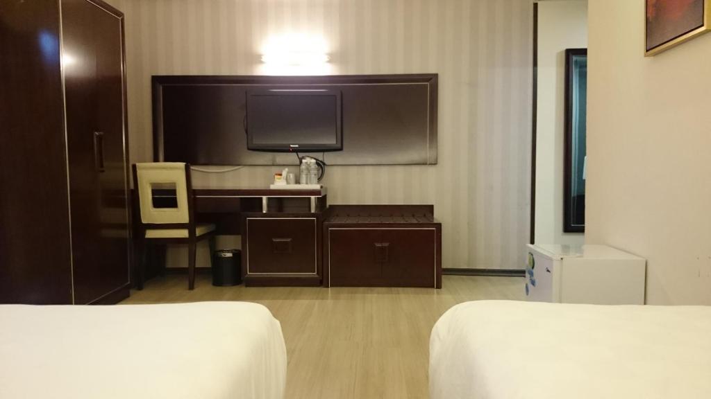 Postel nebo postele na pokoji v ubytování Pariss Hotel