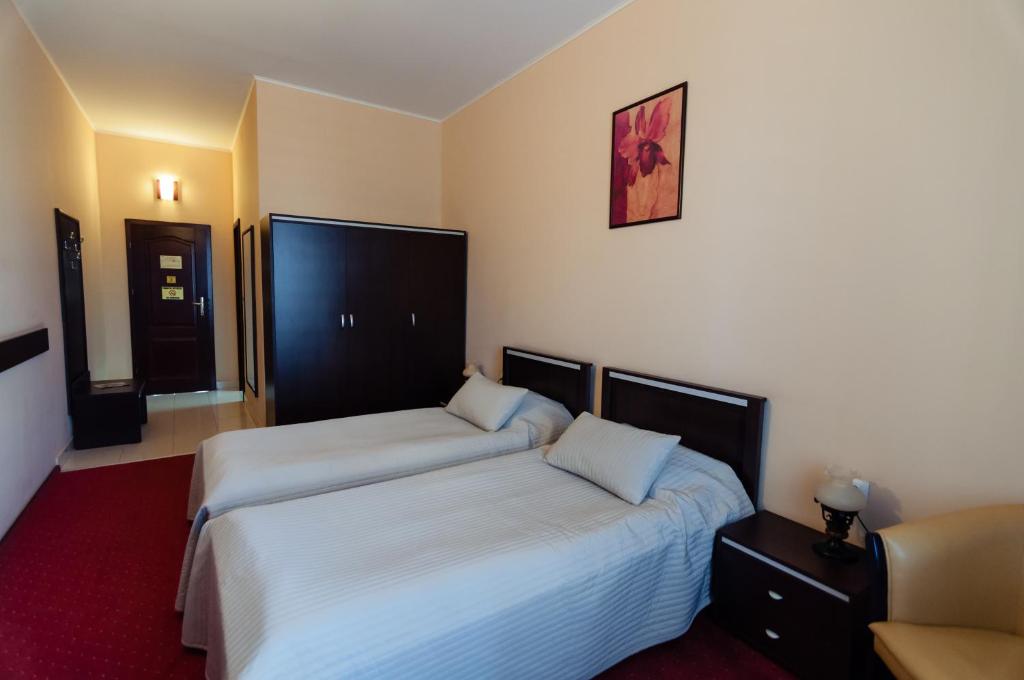 Postel nebo postele na pokoji v ubytování Hotel Magnus Galati